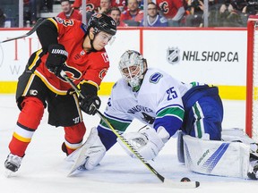 Johnny Gaudreau of the Flames has his shot stopped by Vancouver Canucks goaltender Jacob Markstrom during their game Tuesday night at Scotiabank Saddledome in Calgary.