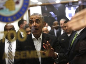 Former President Barack Obama waves to a crowd of people as he attends Cook County jury duty at the Daley Center on November 8, 2017 in Chicago, Illinois.