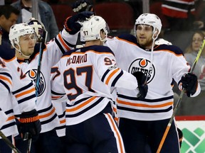 Connor McDavid congratulates Edmonton Oilers teammate Leon Draisaitl after he scored the game winning goal in overtime against the Devils on Thursday night at the Prudential Center in Newark, N.J.