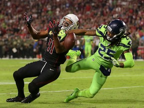 Seahawks cornerback Richard Sherman, right, defends a pass to Cardinals wide receiver Larry Fitzgerald in the first half of the NFL game at University of Phoenix Stadium on Nov. 9, 2017 in Glendale, Arizona.