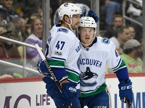 Brock Boeser, right, celebrates with Vancouver Canucks teammate Sven Baertschi after scoring a goal in the first period Wednesday night against the Penguins at PPG Paints Arena in Pittsburgh.