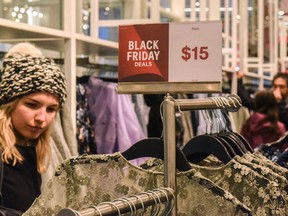 People shop at a H&M store on "Black Friday" on November 24, 2017 in New York City.