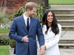 Prince Harry and actress Meghan Markle during an official photocall to announce their engagement at The Sunken Gardens at Kensington Palace on November 27, 2017 in London, England.