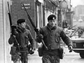 Armed British soldiers patrol on Lisbon Street, Belfast, in 1972, during the Official IRA's unconditional ceasefire.