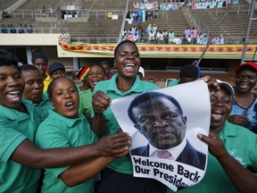 A band holds a picture of Mnangagwa and sings as they await his arrival at the presidential inauguration ceremony of Emmerson Mnangagwa in the capital Harare, Zimbabwe Friday, Nov. 24, 2017. Mnangagwa is being sworn in as Zimbabwe's president after Robert Mugabe resigned on Tuesday, ending his 37-year rule. (AP Photo/Ben Curtis)