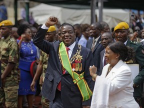 Zimbabwe's President Emmerson Mnangagwa, center, and his wife Auxillia, right, leave after the presidential inauguration ceremony in the capital Harare, Zimbabwe Friday, Nov. 24, 2017. Mnangagwa was sworn in as Zimbabwe's president after Robert Mugabe resigned on Tuesday, ending his 37-year rule. (AP Photo/Ben Curtis)
