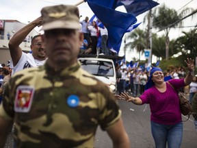 Supporters of Honduran President Juan Orlando Hernandez, who is running for reelection, march to show support for their candidate in Tegucigalpa, Honduras, Tuesday, Nov. 28, 2017. Both Hernandez and his rival Salvador Nasralla, have declared themselves the winner of Sunday's presidential election, but the electoral court said final results would not be announced until Thursday. (AP Photo/Rodrigo Abd)