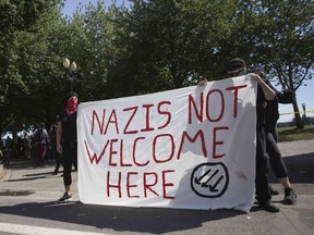 Antifa hold up a sign along a road denouncing Nazis during a protest to oppose the right wing group "The Patriot Prayer Movement," that was having a rally in downtown Portland, Oregon on September 10, 2017.