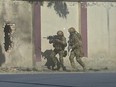 Afghan security personnel take position after gunmen disguised as police stormed a television station in Kabul on November 7, 2017.