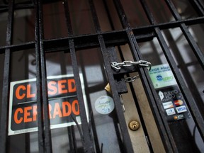 A chain and padlock secures the entrance of a closed down business in San Juan, Puerto Rico on November 7, 2017.