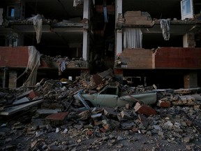 A flattened vehicle underneath building rubble is seen following an earthquake at Sarpol-e Zahab in Iran's Kermanshah province on November 13, 2017.