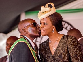 President Robert Mugabe kisses first lady Grace Mugabe on April 18, 2017, during during the Zimbabwe's 37th Independence Day celebrations.