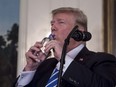 US President Donald Trump drinks water from a bottle as he delivers remarks on November 15, 2017 in the Diplomatic Room at the White House in Washington, DC.