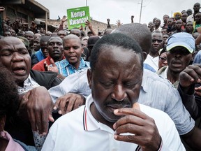 Kenya's opposition party National Super Alliance (NASA) leader Raila Odinga (C) leaves after seeing a dead body on ground at Riverside slum in Nairobi, Kenya, on November 19, 2017.