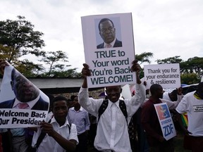 People gather outside Harare's airport to welcome former Zimbabwean vice-president Emmerson Mnangagwa on November 22, 2017 in Harare.