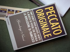 A copy of journalist Gianluigi Nuzzi's latest book "Peccato Originale" (Original Sin) is seen during a press conference to present it, in Rome, Thursday, Nov. 9, 2017. (AP Photo/Andrew Medichini)