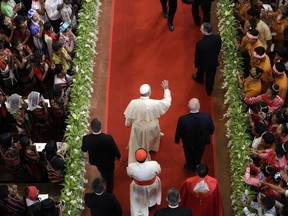 Pope Francis, center, arrives to celebrate a Mass with young people in St. Mary's Cathedral in Yangon, Myanmar, Thursday, Nov. 30, 2017. Francis is wrapping up his visit to Myanmar with a Mass for young people before heading to neighboring Bangladesh where the Rohingya Muslim refugee crisis is expected to take center stage. (AP Photo/Andrew Medichini)