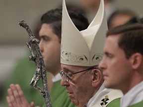 Pope Francis celebrates a mass in St. Peter basilica at the Vatican, Sunday, Nov. 19, 2017. Pope Francis is offering several hundred poor people _ homeless, migrants, unemployed _ a lunch of gnocchi, veal and tiramisu on Sunday as he celebrates his first World Day of the Poor with a concrete gesture of charity in the spirit of his namesake, St. Francis of Assisi. (AP Photo/Andrew Medichini)