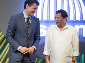 Canadian Prime Minister Justin Trudeau, left, speaks with Philippines President Rodrigo Duterte as he arrives at the opening ceremony for Association of Southeast Asian Nations in Manila, Philippines on Monday, November 13, 2017. THE CANADIAN PRESS/Adrian Wyld