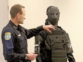Police Chief Eric Jewkes describes the amount of body armor worn using a display of the actual body armor used by suspect Matthew Stover during a Fairbanks Police Department press briefing Thursday afternoon, Nov. 2, 2017 in Fairbanks, Alaska.  The man who was killed in June after firing at officers came prepared to kill, not die, wearing a bullet-proof mask and dressed head to toe in modified body armor, Fairbanks Police Chief Eric Jewkes said. (Eric Engman/Fairbanks Daily News-Miner via AP)