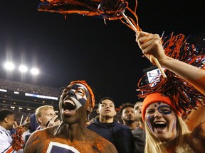 Fans cheer as they rush the field after Auburn defeated Alabama 26-14 in the Iron Bowl NCAA college football game, Saturday, Nov. 25, 2017, in Auburn, Ala. (AP Photo/Brynn Anderson)