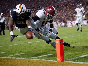 Auburn running back Kerryon Johnson (21) dives for the end zone and gets a first down as Alabama defensive back Ronnie Harrison (15) knocks him out of bounds during the Iron Bowl NCAA football game Saturday, Nov. 25, 2017, in Auburn, Ala. (Albert Cesare/The Montgomery Advertiser via AP)