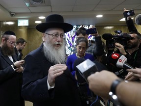 Israeli Health Minister Yaakov Litzman, who is also chairman of the ultra-Orthodox United Torah Judaism party, speaks to journalists after handing in his resignation to Israel's Prime Minister Benjamin Netanyahu, in Jerusalem, Sunday, Nov. 26, 2017.  Litzman resigned on Sunday after the country's railways carried out maintenance work on the Sabbath, when all labor is strictly prohibited by Jewish law. (Gali Tibbon/Pool Photo via AP)