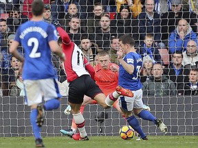 Southampton's Dusan Tadic scores his side's first goal during the English Premier League soccer match between Southampton and Everton, at St Mary's, in Southampton, England, Sunday Nov. 26, 2017. (Mark Kerton/PA via AP)