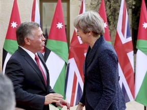 British Prime Minister Theresa May meets King Abdullah at the Royal Palace in Amman, Jordan during her visit to the Middle East, Thursday, Nov. 30, 2017. (AP Photo/Raad Adayleh)