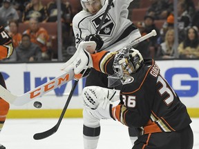 Los Angeles Kings right wing Dustin Brown, top, looks to redirect the puck as Anaheim Ducks goalie John Gibson stops the shot during the first period of an NHL hockey game, Tuesday, Nov. 7, 2017, in Anaheim, Calif. (AP Photo/Mark J. Terrill)
