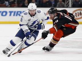 Tampa Bay Lightning center Tyler Johnson (9) controls the puck ahead of Anaheim Ducks right wing Corey Perry (10) during the first period of an NHL hockey game in Anaheim, Calif., Sunday, Nov. 12, 2017. (AP Photo/Christine Cotter)