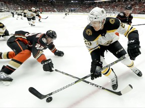 Boston Bruins center Riley Nash battles for the puck with Anaheim Ducks defenseman Francois Beauchemin, left, during the first period of an NHL hockey game in Anaheim, Calif., Wednesday, Nov. 15, 2017. (AP Photo/Chris Carlson)