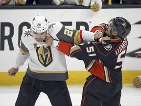 Vegas Golden Knights left winger William Carrier (28) and Anaheim Ducks left winger Mike Liambas (51) fight in the first period of an NHL hockey game in Anaheim, Calif., Wednesday, Nov. 22, 2017. (AP Photo/Reed Saxon)