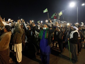 Supporters of the Tehreek-i-Labaik Ya Rasool Allah, a radical religious party, chant religious slogans during a protest at an entrance of Islamabad, Pakistan, Sunday, Nov. 26, 2017. Pakistani Islamists pressed ahead with their rally near Islamabad in even larger numbers on Sunday, a day after clashes with police left six dead and dozens wounded. (AP Photo/Anjum Naveed)