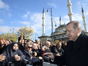 Turkey's President Recep Tayyip Erdogan speaks with people after Friday prayers at a mosque inside his presidential palace in Ankara, Turkey, Friday, Nov. 24. 2017. Erdogan's office says the Turkish leader has discussed the Syrian crisis and other regional issues with U.S. President Donald Trump.  (Pool via AP)
