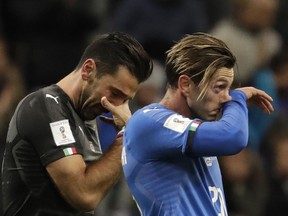 Italian keeper Gianluigi Buffon (left) and striker Manolo Gabbiadini wipe away tears after their team's elimination from the 2018 World Cup at the hands of Sweden on Nov. 13.