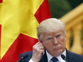 U.S. President Donald Trump attends a press conference at the Presidential Palace in Hanoi, Vietnam Sunday, Nov. 12, 2017.