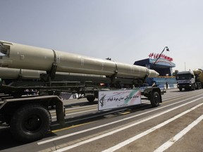 FILE - In this Friday, Sept. 21, 2012 file photo, a Qiam missile is displayed by Iran's Revolutionary Guard during a military parade commemorating the start of the Iraq-Iran war in front of the mausoleum of the late revolutionary founder Ayatollah Khomeini just outside Tehran, Iran. Saudi Arabia and the U.S. now accuse Iran of supplying ballistic missiles to Shiite rebels in Yemen, including this model. (AP Photo/Vahid Salemi, File)