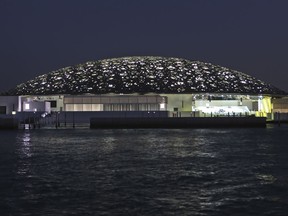 This Monday, Nov. 6, 2017, photo, shows the night view of the Louvre Abu Dhabi, United Arab Emirates. The museum, which opens on Saturday to the public, encompasses work from both the East and West. (AP Photo/Kamran Jebreili)