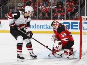 Cory Schneider of the New Jersey Devils makes a third-period save against Clayton Keller of the Arizona Coyotes at the Prudential Center on Oct. 28, 2017.