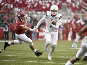 Mississippi State quarterback Nick Fitzgerald slips past Arkansas defender Grant Morgan to score a touchdown during the first half of an NCAA college football game Saturday, Nov. 18, 2017, in Fayetteville, Ark. (AP Photo/Michael Woods)