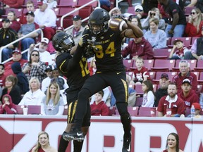 Missouri receiver Emanuel Hall (84) celebrates with teammate Jonathon Johnson after scoring a touchdown against Arkansas in the first half of an NCAA college football game Friday, Nov. 24, 2017 in Fayetteville, Ark. (AP Photo/Michael Woods)