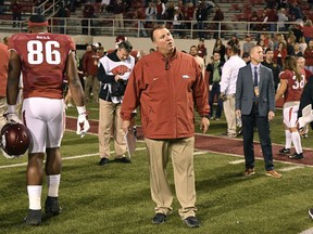Arkansas coach Bret Bielema waits for his team to leave the field after their loss to Missouri in an NCAA college football game Friday, Nov. 24, 2017 in Fayetteville, Ark. (AP Photo/Michael Woods)