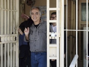 Dimitris Koufodinas, 59, smiles as he leaves Korydallos prison in western Athens, Thursday, Nov. 9, 2017. Koufodinas, the gunman for the now-defunct Greek extremist group November 17, has been granted a 48-hour furlough from an Athens jail, fueling a political debate on prison sentencing and law and order in Greece. (Yannis Kotsiaris/InTime News via AP)