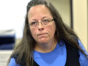 FILE- In this Sept. 1, 2015, file photo, Rowan County Clerk Kim Davis listens to a customer at the Rowan County Courthouse in Morehead, Ky. Davis, who spent five days in jail for refusing to issue marriage licenses to same-sex couples, will run for re-election in 2018, the first chance voters will get to have a say on the controversy that dominated national news. (AP Photo/Timothy D. Easley, File)
