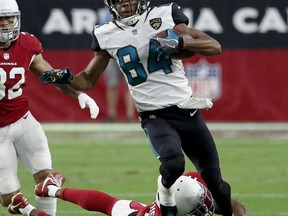 Jacksonville Jaguars wide receiver Keelan Cole (84) is tripped up by Arizona Cardinals strong safety Antoine Bethea (41) during the second half of an NFL football game, Sunday, Nov. 26, 2017, in Glendale, Ariz. (AP Photo/Rick Scuteri)