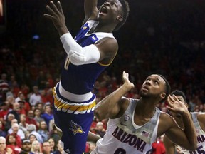 Cal State Bakersfield guard Jarkel Joiner (0) drives past Arizona guard Parker Jackson-Cartwright in the first half during an NCAA college basketball game, Thursday, Nov. 16, 2017, in Tucson, Ariz. (AP Photo/Rick Scuteri)