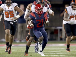 Arizona running back J.J. Taylor (21) leaves the Oregon State defense behind on a long run during the second quarter of an NCAA college football game Saturday, Nov. 11, 2017, Tucson, Ariz. (Kelly Presnell/Arizona Daily Star via AP)