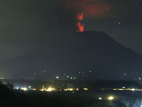 A view of the Mount Agung volcano erupting, in Karangasem, Bali island, Indonesia, early Sunday.