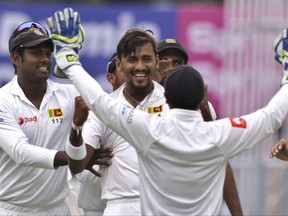 Sri Lanka's Suranga Lakmal, center without cap, celebrates with teammates the dismissal of India's Lokesh Rahul during the first day of their first test cricket match in Kolkata, India, Thursday, Nov. 16, 2017. (AP Photo/Bikas Das)